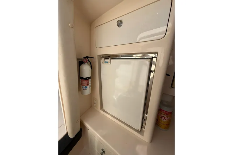 Yacht Photos Pics 2008 Intrepid 370 Cuddy interior with fire extinguisher and storage compartment.