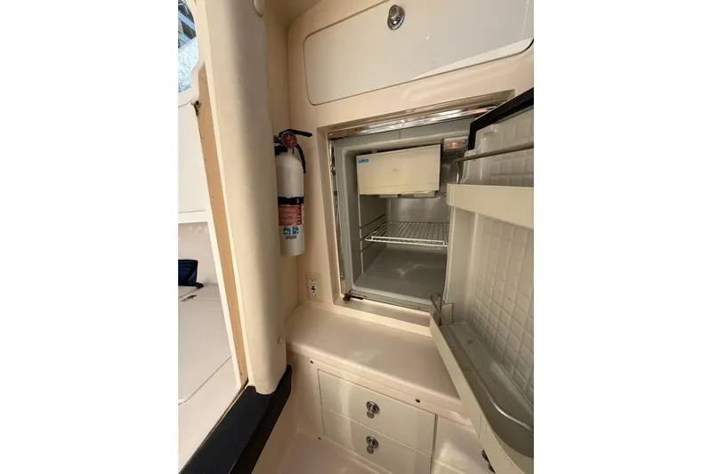  Yacht Photos Pics 2008 Intrepid 370 Cuddy interior with open fridge and fire extinguisher.