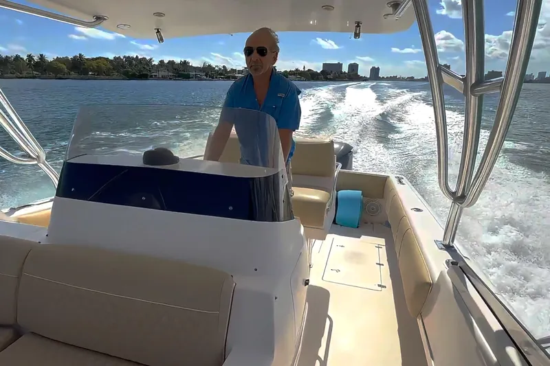  Yacht Photos Pics 2008 Intrepid 370 Cuddy cruising on sunny waters, with a person at the helm.