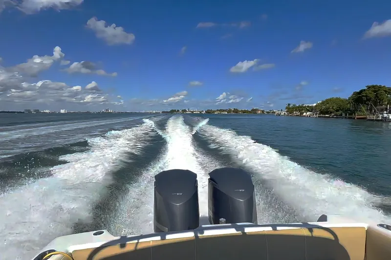  Yacht Photos Pics Intrepid 370 Cuddy 2008 cruising on open water, leaving a wake under a clear blue sky.