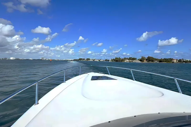  Yacht Photos Pics 2008 Intrepid 370 Cuddy cruising on a sunny day with clear skies and calm waters.