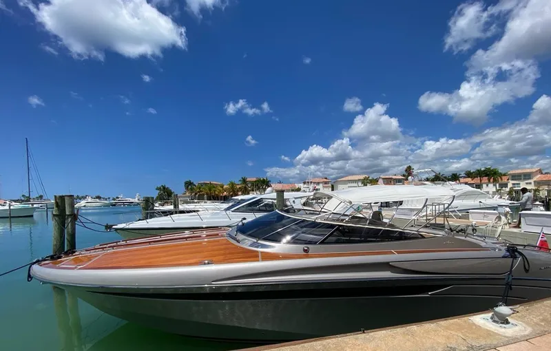  Yacht Photos Pics Luxury 2006 Riva RAMA 44' yacht docked under a clear blue sky.