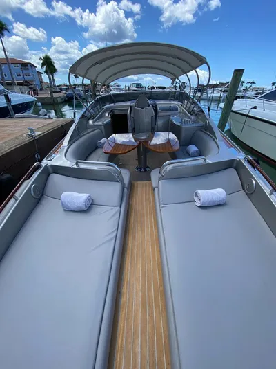  Yacht Photos Pics Luxury 2006 Riva RAMA 44' yacht with sunbeds and canopy, docked at marina.