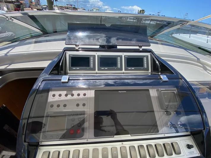  Yacht Photos Pics Control panel of 2006 Riva RAMA 44' yacht with navigation screens.