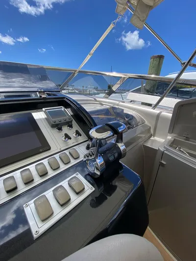  Yacht Photos Pics Control panel of a 2006 Riva RAMA 44' yacht under a clear blue sky.