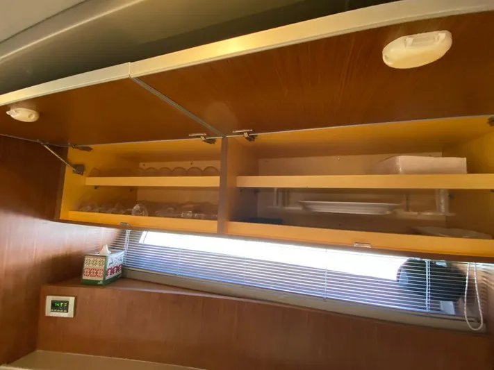  Yacht Photos Pics Interior of 2006 Riva RAMA 44' yacht with wooden cabinets and shelves.