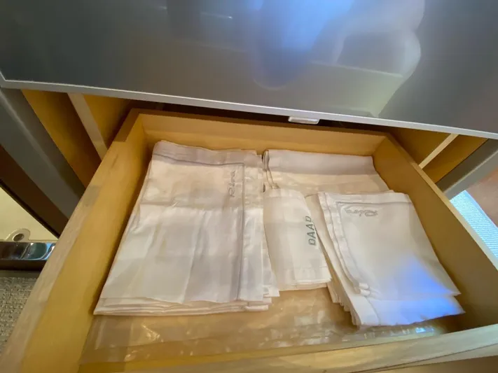  Yacht Photos Pics Drawer with neatly folded white linens on a Riva RAMA 44' yacht, 2006 model.