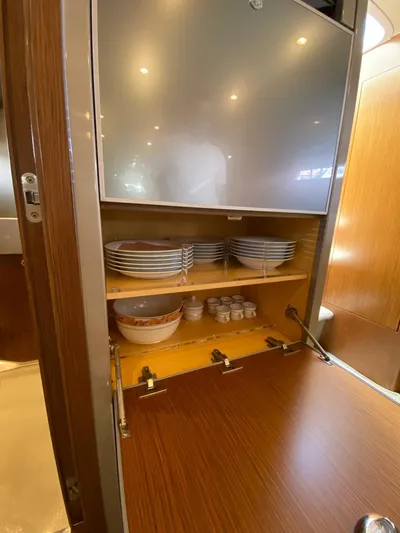  Yacht Photos Pics Cabinet interior of 2006 Riva RAMA 44' yacht with plates and bowls.