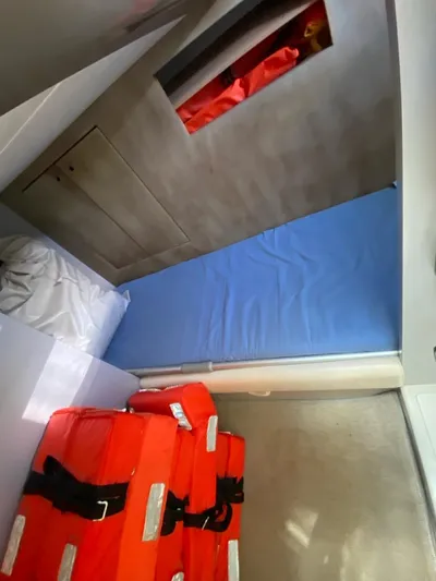  Yacht Photos Pics Interior cabin of 2006 Riva RAMA 44' with blue bedding and orange life jackets.