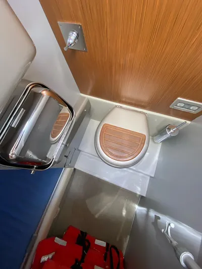  Yacht Photos Pics 2006 Riva RAMA 44' yacht bathroom with wooden toilet seat and modern fixtures.