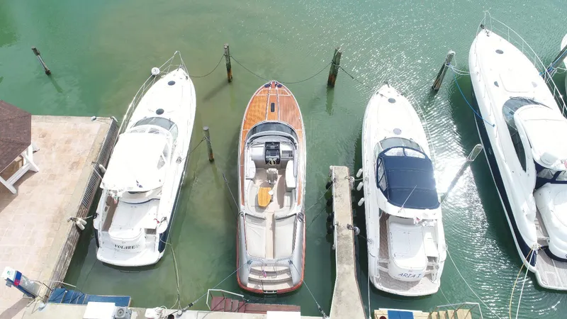  Yacht Photos Pics Aerial view of a 2006 Riva RAMA 44' yacht docked among other boats.