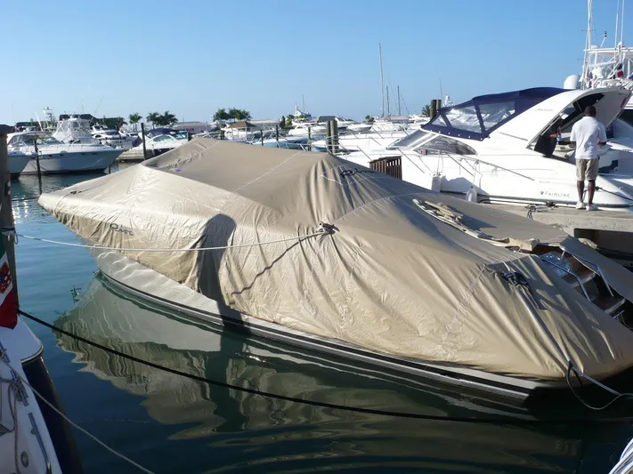  Yacht Photos Pics Covered 2006 Riva RAMA 44' yacht docked at marina with other boats.