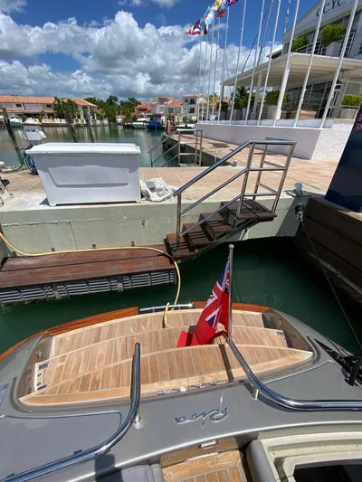  Yacht Photos Pics Luxury 2006 Riva RAMA 44' yacht docked at marina under clear skies.