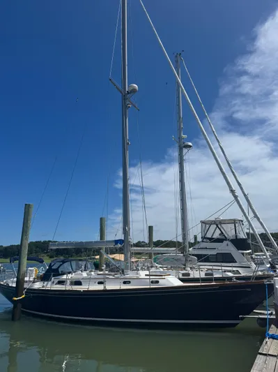 Mast Transit Yacht Photos Pics 1983 Hinckley Sou'wester 42 sailboat docked under clear blue sky.