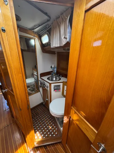 Mast Transit Yacht Photos Pics Interior of 1983 Hinckley Sou'wester 42 yacht bathroom with wooden finish and compact design.