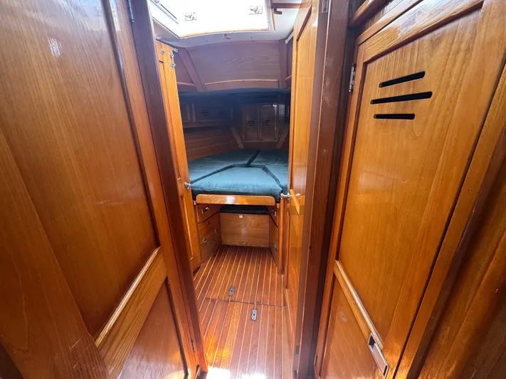 Mast Transit Yacht Photos Pics Interior cabin of 1983 Hinckley Sou'wester 42 sailboat with wooden finish and cozy bed.