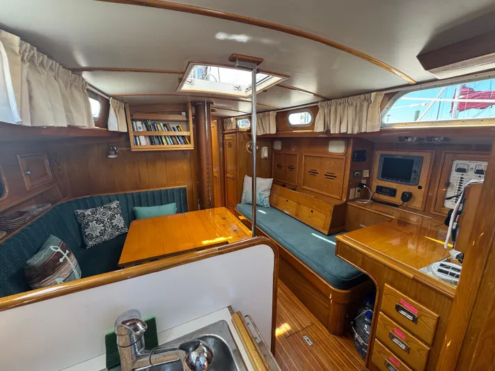 Mast Transit Yacht Photos Pics Interior of 1983 Hinckley Sou'wester 42 sailboat with wood finish and seating area.