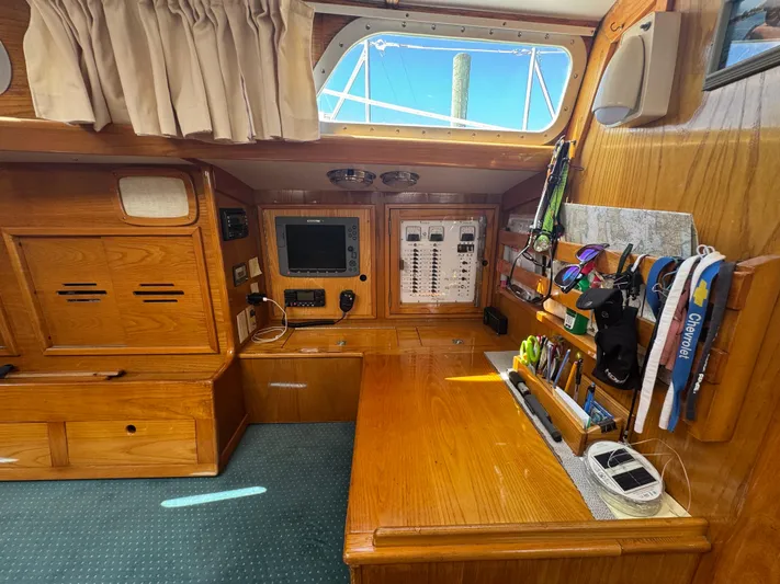 Mast Transit Yacht Photos Pics Interior of 1983 Hinckley Sou'wester 42 sailboat with navigation station and wooden cabinetry.
