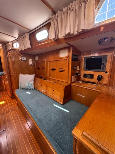 Mast Transit Yacht Photos Pics Interior of 1983 Hinckley Sou'wester 42 sailboat with wooden cabinetry and cushioned seating.