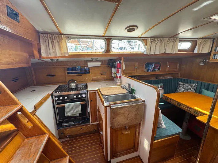 Mast Transit Yacht Photos Pics 1983 Hinckley Sou'wester 42 yacht interior with kitchen, dining area, and wooden finishes.