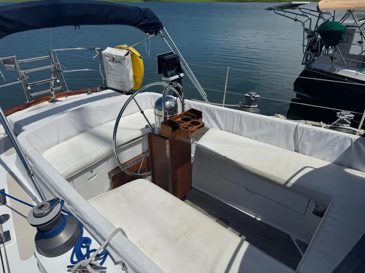 Mast Transit Yacht Photos Pics Cockpit of 1983 Hinckley Sou'wester 42 sailboat with white seating and steering wheel.