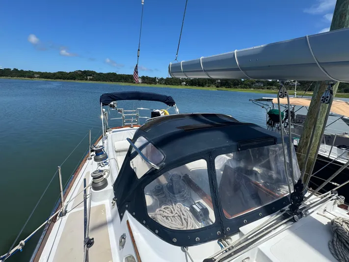 Mast Transit Yacht Photos Pics 1983 Hinckley Sou'wester 42 sailboat docked on calm water under clear blue sky.