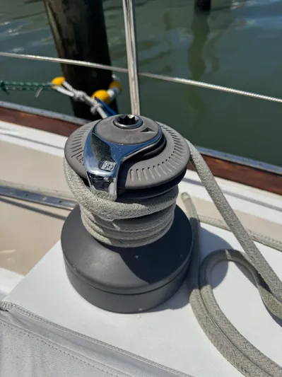 Mast Transit Yacht Photos Pics Winch on 1983 Hinckley Sou'wester 42 sailboat, rope coiled, docked by water.