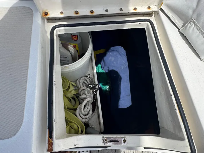 Mast Transit Yacht Photos Pics Open storage compartment on 1983 Hinckley Sou'wester 42 sailboat, containing ropes and cleaning supplies.