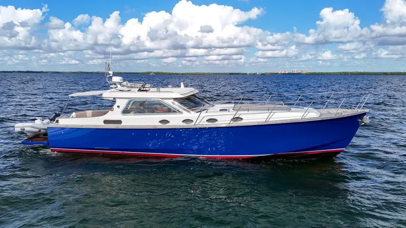  Yacht Photos Pics Luxury 2010 Revival 45 Gentlemans yacht on open water, blue hull, clear sky.