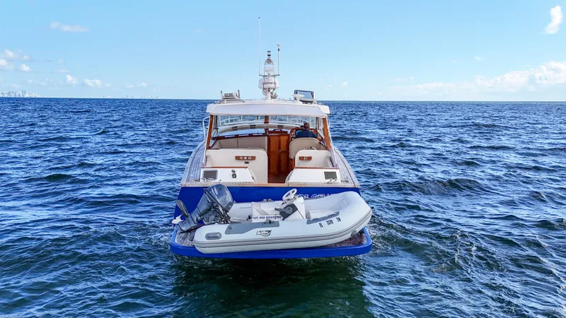  Yacht Photos Pics A 2010 Revival 45 Gentlemans yacht on open water with a small boat attached.