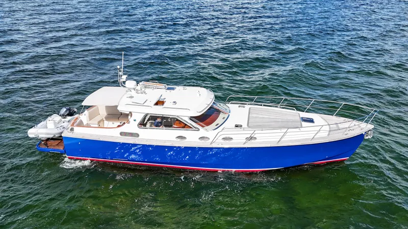  Yacht Photos Pics A 2010 Revival 45 Gentlemans yacht cruising on open water, featuring a sleek blue and white design.