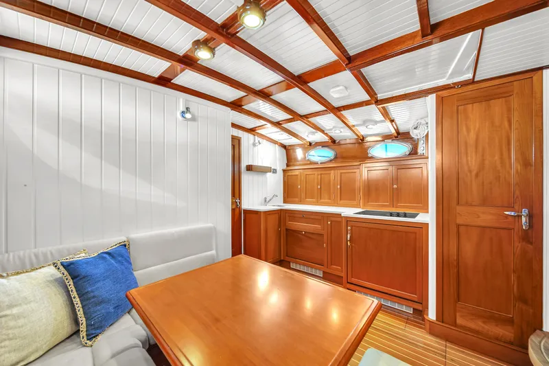  Yacht Photos Pics Luxurious interior of 2010 Revival 45 Gentlemans yacht with wooden cabinetry and cozy seating area.