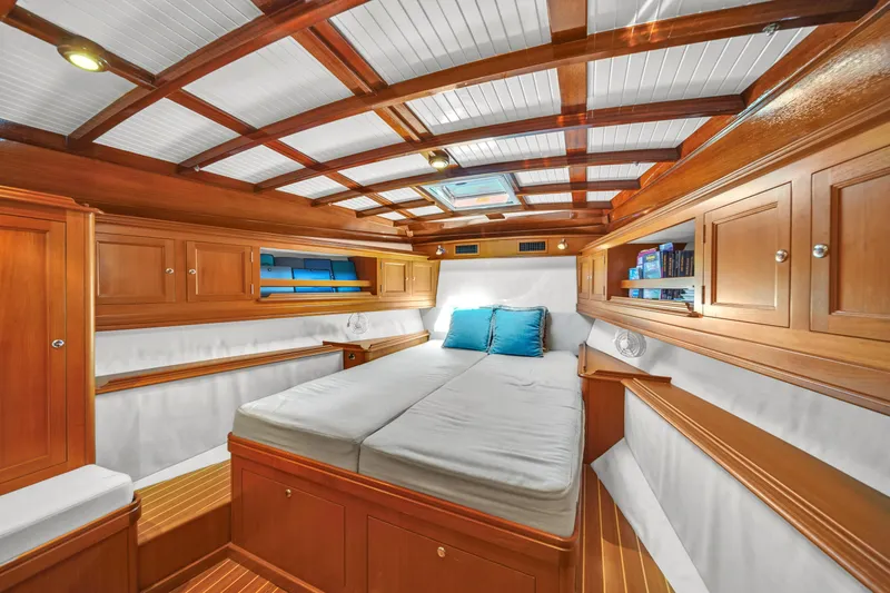  Yacht Photos Pics Luxurious cabin interior of 2010 Revival 45 Gentlemans yacht with wooden finish and cozy bedding.
