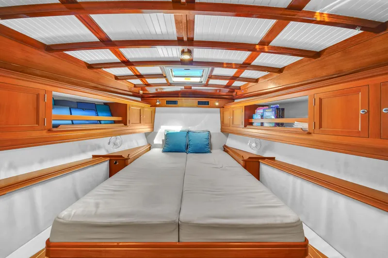  Yacht Photos Pics Luxurious cabin interior of 2010 Revival 45 Gentlemans yacht with wooden accents and cozy bedding.