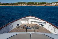 Bow view of 2009 Maiora 31 yacht cruising near a scenic coastline.