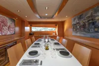 Luxurious dining area on 2009 Maiora 31 yacht, featuring elegant table setting and modern decor.