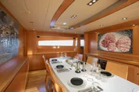 Luxurious dining area on 2009 Maiora 31 yacht with elegant table setting and modern decor.