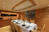 Luxurious dining area on 2009 Maiora 31 yacht, featuring elegant table setting and modern decor.