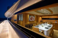 Luxurious dining area on 2009 Maiora 31 yacht, elegantly set table at night.