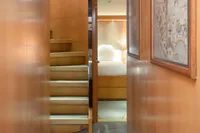 Interior hallway of 2009 Maiora 31 yacht with wooden walls and staircase.