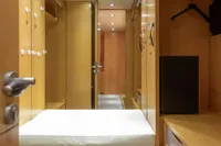 Luxurious wooden interior of 2009 Maiora 31 yacht with modern lighting and storage.