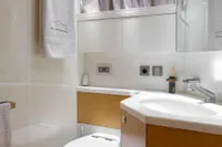 Luxurious bathroom in a 2009 Maiora 31 yacht, featuring modern fixtures and elegant design.