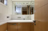 Luxurious bathroom interior on a 2009 Maiora 31 yacht, featuring modern fixtures and mirrored cabinets.