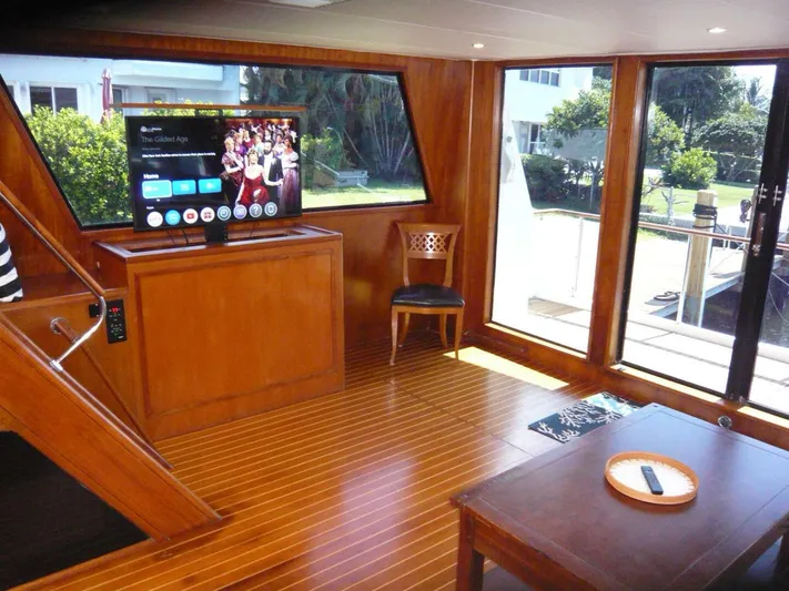 Vitamin Sea Yacht Photos Pics Interior of 1990 Viking Cockpit Motor Yacht with wooden flooring and modern TV setup.