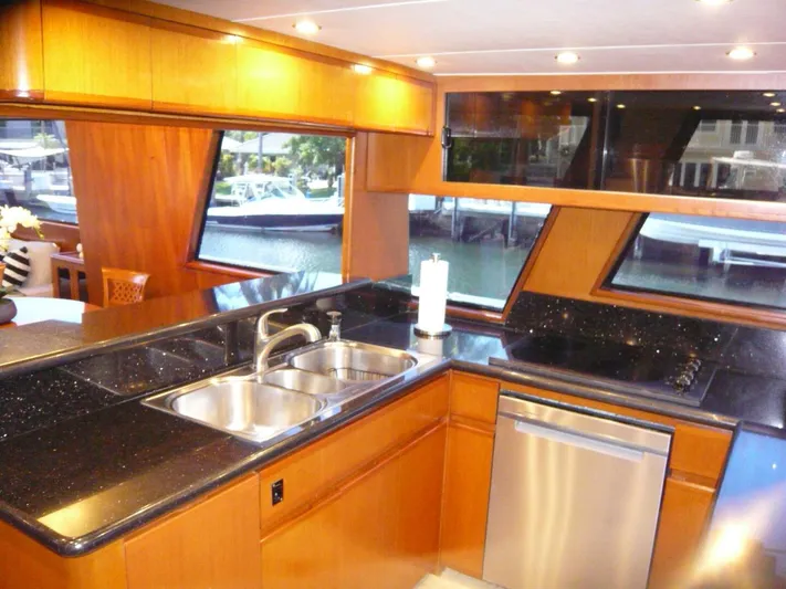 Vitamin Sea Yacht Photos Pics Luxurious kitchen interior of a 1990 Viking Cockpit Motor Yacht with sleek countertops.