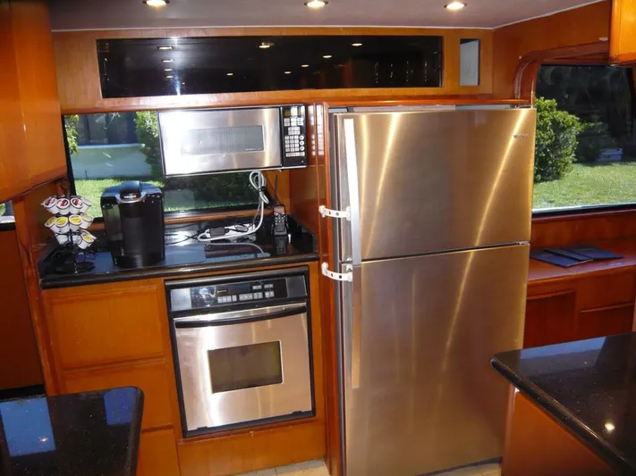 Vitamin Sea Yacht Photos Pics Modern kitchen in a 1990 Viking Cockpit Motor Yacht with stainless steel appliances.