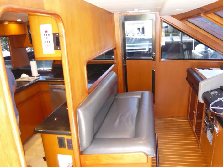 Vitamin Sea Yacht Photos Pics Interior of 1990 Viking Cockpit Motor Yacht with wood paneling and seating area.