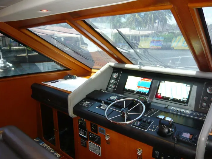 Vitamin Sea Yacht Photos Pics Cockpit of 1990 Viking Motor Yacht with navigation screens and steering wheel.