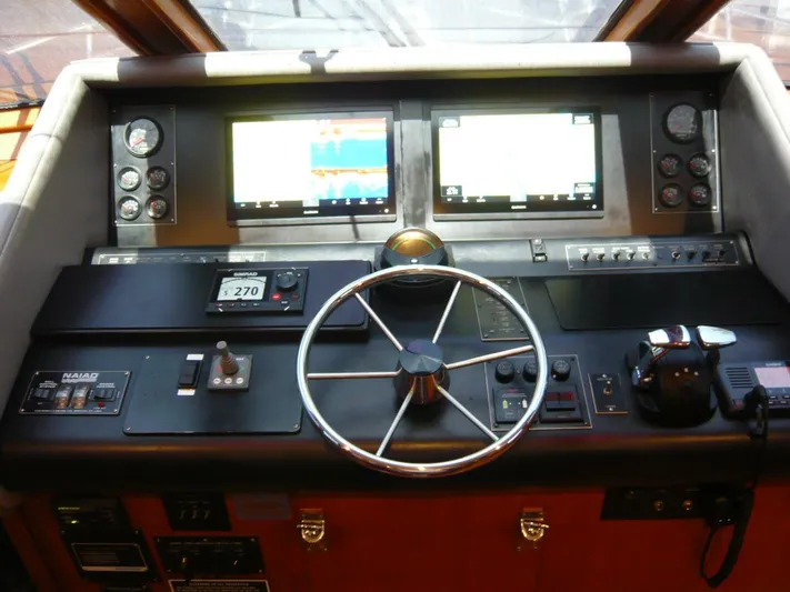 Vitamin Sea Yacht Photos Pics Cockpit of 1990 Viking Motor Yacht with steering wheel and navigation screens.