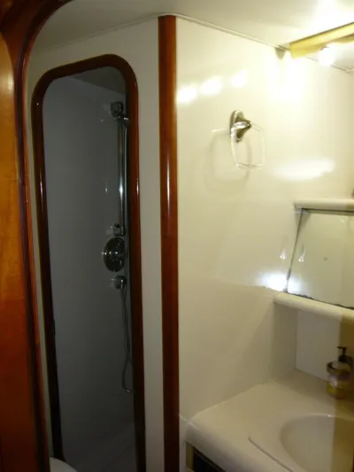 Vitamin Sea Yacht Photos Pics Bathroom interior of 1990 Viking Cockpit Motor Yacht with shower and sink.